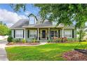Charming two-story home with a well-maintained lawn, complemented by lush landscaping and mature trees at 1935 Austin Ter, Winter Haven, FL 33884