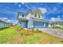Charming two-story home featuring a well-maintained lawn and a brick paver driveway at 4694 Grandview Glen Dr, Auburndale, FL 33823
