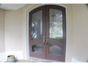 Close up of the entryway featuring beautiful double doors with glass panels and an arched transom at 108 Lake Region N Blvd, Winter Haven, FL 33881