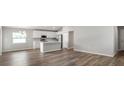 Open-concept living area features wood flooring and integrates with a modern kitchen at 572 Sw 77Th Cir, Ocala, FL 34480