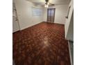 Cozy living area featuring unique patterned floors, a ceiling fan, and ample natural light at 3203 Decatur Ave, Lakeland, FL 33805
