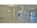 Open-concept living space with tile flooring, bright lighting, and a view of the modern kitchen at 5126 Villa Crest Way, Auburndale, FL 33823