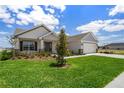 Beautiful single-Gathering home with a lush green lawn and stone-accented entryway at 1365 Melrose St, Lake Alfred, FL 33850