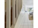 Bright hallway with tiled flooring leading to the living room with a sliding glass door at 1836 N Crystal Lake Dr # 46, Lakeland, FL 33801