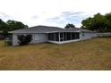 Back of house features a screened-in patio, perfect for outdoor relaxation at 2556 Roslyn Ln, Lakeland, FL 33812