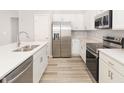 Bright kitchen with stainless steel appliances, white cabinets, and a spacious countertop at 3166 Laurel Oak Ln, Winter Haven, FL 33884