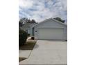 Light blue one-story house with a two-car garage at 4197 Cannes Ave, Lake Wales, FL 33859