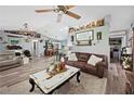 Spacious living room features a ceiling fan, wood-look flooring, and seamless access to the dining area at 6155 Bethlehem Rd, Mulberry, FL 33860