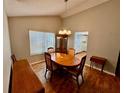 Dining room featuring an oval table set, chandelier, and large window at 6718 Trail Ridge Dr, Lakeland, FL 33813