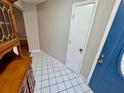Inviting entryway with classic tile flooring and blue front door at 6718 Trail Ridge Dr, Lakeland, FL 33813