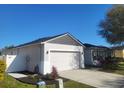 Well-maintained house featuring a spacious two-car garage and tidy landscaping in a suburban neighborhood at 6799 Glenbrook Dr, Lakeland, FL 33811