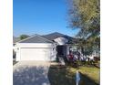 Charming single-story home with a well-manicured lawn and a two-car garage, perfect for a Gathering at 6799 Glenbrook Dr, Lakeland, FL 33811