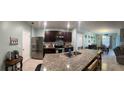 A spacious kitchen with granite countertops, stainless steel appliances and an island with a sink at 3136 Country Club Cir, Winter Haven, FL 33881