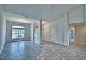 Spacious open-concept living room with tile flooring, neutral walls, and abundant natural light at 4050 Tullamore Ln, Auburndale, FL 33823