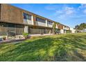 Rear view of condo building showcasing green space at 6123 Topher Trl # 63C, Mulberry, FL 33860