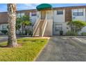 Condo building entrance with stairs and landscaping at 6123 Topher Trl # 63C, Mulberry, FL 33860