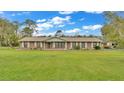 Charming brick home with a well-manicured lawn and classic shutters at 9240 Moore Rd, Lakeland, FL 33809