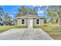 Newly constructed home with a green exterior, white trim, and a spacious yard at 110 5Th Sw St, Fort Meade, FL 33841