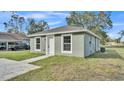 Newly built home with green exterior, white trim, and a concrete driveway at 110 5Th Sw St, Fort Meade, FL 33841