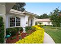 Well-maintained landscaping and a walkway to the entrance at 202 Golf Aire Blvd, Winter Haven, FL 33884
