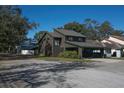View of home showing modern architectural details, mature trees, and a neighborhood setting at 3597 Raintree Ln, Lakeland, FL 33803