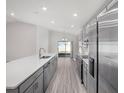 Modern kitchen featuring stainless steel appliances, gray cabinets, and an island at 468 Ituna Cir, Winter Haven, FL 33881