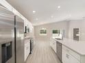 Bright open kitchen featuring stainless steel appliances, white cabinets, and large island at 596 Ituna Cir, Winter Haven, FL 33881