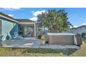 Private backyard featuring a relaxing hot tub, screened-in patio, and lush tropical landscaping for serene outdoor living at 7525 Jessamine Dr, Lakeland, FL 33810