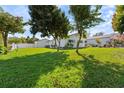 Well-maintained home with a spacious green lawn and mature trees, offering a serene and inviting outdoor space at 1323 Valley E Hl, Lakeland, FL 33813