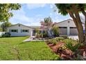 Inviting single-story home featuring fresh landscaping and a two-car garage, complemented by a well-manicured lawn at 1323 Valley E Hl, Lakeland, FL 33813