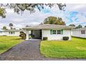 Single story home with carport and well-maintained lawn at 561 Cameo Dr, Lakeland, FL 33803