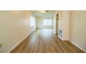 Bright living room features wood-look flooring and natural light from multiple windows at 561 Cameo Dr, Lakeland, FL 33803