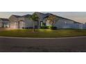 Beautiful home with a manicured lawn, mature landscaping, and inviting curb appeal at 185 St Thomas Dr, Mulberry, FL 33860