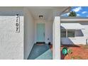 Inviting front entrance with a light teal door and walkway at 3107 Valley High Dr, Lakeland, FL 33813