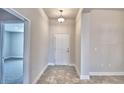 This entryway has neutral walls, tile floors, and a white door at 4036 Tullamore Ln, Auburndale, FL 33823