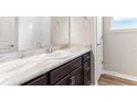 Bathroom featuring a marble vanity top, a mirror, and a white tiled wall at 715 Sw 77Th Cir, Ocala, FL 34474