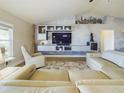 Stylish living room with a modern entertainment center and comfortable seating at 1155 Towergate Cir, Lake Wales, FL 33853