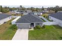 One-story house with gray roof and white fence, in a residential area at 1225 Third Ct, Eagle Lake, FL 33839