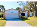 Charming one-story home with a large front yard and attached garage at 3709 Feather Dr, Lakeland, FL 33812
