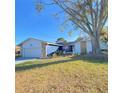 Renovated single story home with a landscaped yard and large tree at 3709 Feather Dr, Lakeland, FL 33812