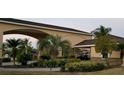 Welcoming entrance with lush landscaping and a covered drive at 535 Narrow Pond Rd, Polk City, FL 33868