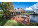 Wooden dock with a seating area overlooking the serene waterfront at 6029 Avocado Dr, Indian Lake Estates, FL 33855