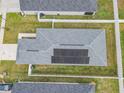 Aerial view of a home with solar panels, fenced yard, and a concrete driveway at 1354 Mezzavalle Way, Auburndale, FL 33823