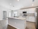 Bright kitchen featuring a central island with a sink and modern appliances at 1354 Mezzavalle Way, Lakeland, FL 33801