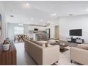 Open-concept living space with modern finishes connecting the kitchen, dining, and living areas at 1354 Mezzavalle Way, Auburndale, FL 33823