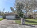 House exterior with a two-car garage and mature landscaping at 3940 Laurel Branch Dr, Lakeland, FL 33810