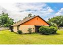 Charming single-story home featuring a well-maintained lawn and lush landscaping at 5058 Cimarron Dr, Lakeland, FL 33813