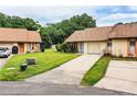 Well-maintained single-story home with an attached garage, long driveway, and green lawn with minimal landscaping at 5058 Cimarron Dr, Lakeland, FL 33813