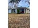 Gray house with covered porch and landscaping at 520 Green Cir, Fort Meade, FL 33841