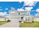 Charming two-story home with a well-manicured lawn and attached two car garage at 5460 Siltstone St, Lakeland, FL 33811